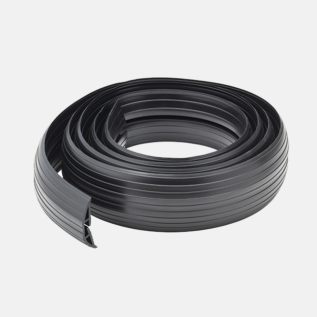 A black rubber cable floor cover protector